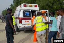FILE - Rescue workers are seen at the site of an attack by Boko Haram militants in the northeast city of Maiduguri, Nigeria, April 27, 2018.