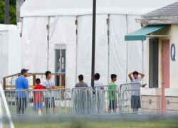 FILE - Immigrant children walk in a line outside the Homestead Temporary Shelter for Unaccompanied Children, a former Job Corps site that now houses them in Homestead, Fla., June 20, 2018.