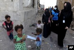 Aktris Hollywood dan utusan khusus untuk PBB Angelina Jolie (kanan), bersama staf UNHCR berjalan di sekitar kamp darurat untuk pengungsi Yaman di Al Kandam, Yaman Minggu, 6 Maret 2022. (Marwan Tahtah/UNHCR via AP)