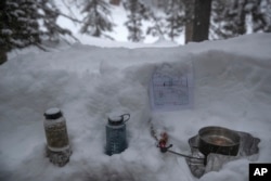 U.S. Marines boils water in a trench during advanced cold-weather training at the Marine Corps Mountain Warfare Training Center Saturday, Feb. 9, 2019, in Bridgeport, Calif. (AP Photo/Jae C. Hong)