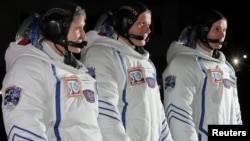 International Space Station crew members, from left, American Peggy Whitson, Russian Oleg Novitskiy and Frenchman Thomas Pesquet are seen before the launch of the Soyuz spacecraft at the Baikonur cosmodrome, Kazakhstan, Nov. 17, 2016. 
