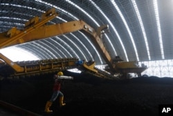 Coal is being stored for the Maitree Super Thermal Power Project near the Sundarbans, the world’s largest mangrove forest, in Rampal, Bangladesh, Monday, Oct. 17, 2022.