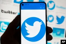 The Twitter logo is seen on a cell phone, Friday, Oct. 14, 2022, in Boston, Massachusetts. (AP Photo/Michael Dwyer)