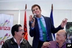 Opposition Alliance presidential candidate Salvador Nasralla, center, speaks during a press conference accompanied by ousted Honduran President Manuel Zelaya, left, and union leader Carlos Reyes in Tegucigalpa, Honduras, Dec. 7, 2017.
