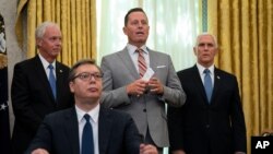 President Donald Trump’s special envoy on Serbia and Kosovo Richard Grenell speaks during a signing ceremony with Serbian President Aleksandar Vucic sitting at a desk in the Oval Office of the White House in Washington, Sept. 4, 2020. 