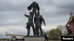 A Soviet monument to a friendship between Ukrainian and Russian nations is seen before its demolition, in central Kyiv, Ukraine April 26, 2022.