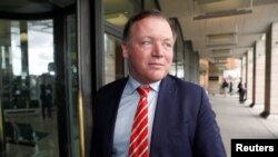 FILE - British lawmaker Damian Collins arrives at Portcullis House in Westminster, London, April 26, 2018.