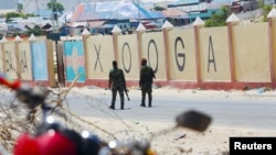 Somali military soldiers loyal to Prime Minister Mohamed Hussein Roble patrol outside the Aden Adde International Airport where members of the Lower House of Parliament are meeting to elect a speaker, in Mogadishu, Somalia, April 27, 2022.