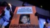 Activists hold posters against the impending execution of Nagaenthran K. Dharmalingam, sentenced to death for trafficking heroin into Singapore, during a candlelight vigil gathering outside the Singaporean Embassy in Kuala Lumpur, Malaysia, Tuesday, April