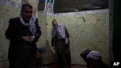 FILE - Hazara men pray inside a Shiite shrine in Kabul, Afghanistan, Nov. 5, 2021.