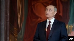 Russian President Vladimir Putin attends the Orthodox Easter service in the Christ the Savior Cathedral in Moscow, Russia, April 24, 2022.
