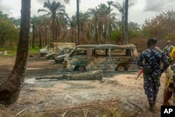 FILE - People gather at the site of an explosion at an illegal oil bunkering site in the Egbema local government area, Imo state, in southeastern Nigeria, April 24, 2022.