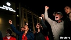 People outside the Justice Palace in Istanbul shout slogans after a Turkish court sentenced philanthropist Osman Kavala to life in prison, April 25, 2022