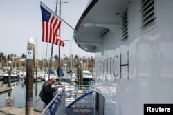 All American Marine project manager Matt Riedel disembarks the Sea Change while it is docked at Squalicum Harbor in Bellingham, Washington, U.S., April 7, 2022. (REUTERS/Matt Mills McKnight)