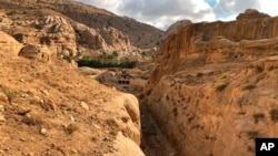 This file photo shows where a dam was built in the 1960's by the Department of Antiquities, and the ancient Mudlim tunnel, both built to protect the area from flooding, in Petra, Jordan, Nov. 15, 2018. (AP Photo/Laure Van Ruymbeke, file)