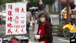 People wear face masks to protect against the spread of COVID-19 in Taipei, April 26, 2022.