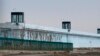FILE - A person stands in a tower on the perimeter of the No. 3 Detention Center in Dabancheng in western China's Xinjiang Uyghur Autonomous Region on April 23, 2021. Human rights groups and Western nations have accused China of massive crimes against the Uyghur minority.
