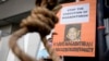 FILE - An activist holds poster against the impending execution of Nagaenthran K. Dharmalingam, sentenced to death for trafficking heroin into Singapore, during a gathering outside the Singaporean Embassy in Kuala Lumpur, Malaysia, April 23, 2022. 