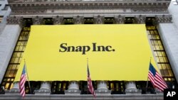 A banner for Snap Inc. hangs from the front of the New York Stock Exchange, March 2, 2017, in New York. 
