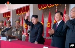 FILE - In an image made from video, North Korean leader Kim Jong Un, center, and Liu Yunshan, China's Communist Party's No. 5 leader, second right, waves during a ceremony in Pyongyang.