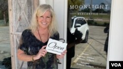 Lisa Ash stands in front of her shop in Mandeville, Louisiana. Like many Americans concerned about the downturn and their shrinking lifelong savings, Ash, 62, says "the economy has affected those of us preparing for retirement in a big way." (Matt Haines/VOA)