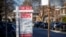 FILE - A realtor's "for sale" sign is posted outside a home in Toronto, Canada, Dec. 13, 2021. 