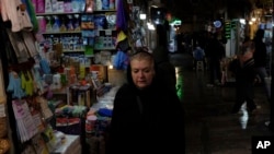 A woman walks through Tajrish bazaar in northern Tehran, Iran, Monday, Dec. 5, 2022. Confusion over the status of Iran’s religious police grew as state media cast doubt on reports the force had been shut down. (AP Photo/Vahid Salemi)
