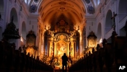 A man walks through the St. Anna basilica in Altoetting, some 90 kilometers east of Munich near Marktl, the birthplace of Pope emeritus Benedict XVI, Germany, Dec. 29, 2022. 