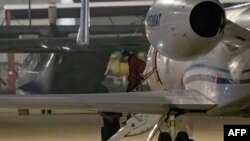 WNBA star Brittney Griner exits a plane in San Antonio, Texas, after she was released from a Russian prison in exchange for an arms dealer.