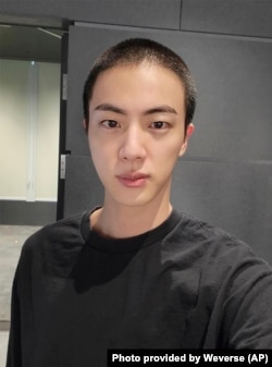 Jin of K-pop band BTS shows off freshly shaved hair on the K-pop social media platform Weverse, which was uploaded Dec. 11, 2022, ahead of his upcoming military conscription.