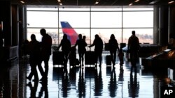 People pass through Salt Lake City International Airport, Jan. 11, 2023, in Salt Lake City. 