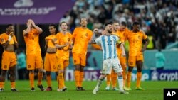 Argentina's Lionel Messi celebrates in front of Netherlands players after their World Cup soccer match at Lusail, Qatar, Dec. 9, 2022.