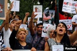 FILE - After the death of Mahsa Amini, demonstrators protest outside the Iranian Embassy in Athens, Greece, Sept. 27, 2022. (REUTERS/Costas Baltas)