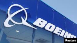 FILE - Signage for Boeing is seen on a trade pavilion, July 19, 2022. 