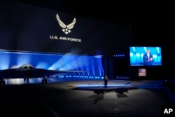 Secretary of Defense Lloyd Austin introduces the B-21 Raider stealth at Northrop Grumman Friday, Dec. 2, 2022, in Palmdale, Calif. The B-21 Raider is the first new American bomber aircraft in more than 30 years. Almost every aspect of the program is classified. (AP Photo/Marcio Jose Sanchez)