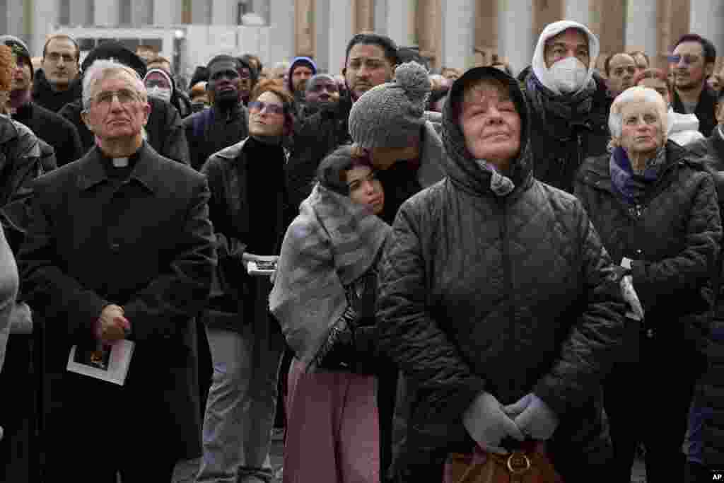 Faithful attend the funeral mass for late Pope Emeritus Benedict XVI in St. Peter's Square at the Vatican, Jan. 5, 2023.
