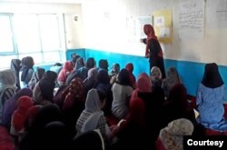FILE - Girls barred from education by Taliban study in a secret school run by volunteers in Afghanistan in this undated photo. (Photo courtesy Parasto)