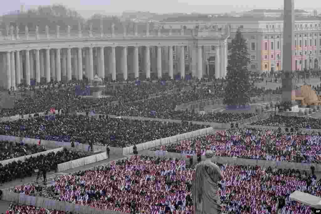 Faithful attend the funeral mass for late Pope Emeritus Benedict XVI in St. Peter's Square at the Vatican, Jan. 5, 2023.