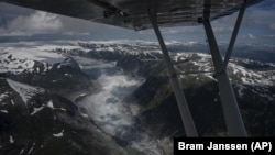 A glacier is seen from Garrett Fisher's plane in Norway on July 30, 2022. (AP Photo/Bram Janssen)
