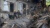 Ukrainian State Emergency Service firefighters clear the rubble at a building that was destroyed by a Russian attack in Kryvyi Rih, Ukraine, Dec. 16, 2022.