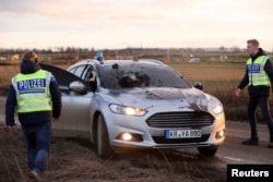 A damaged police civil car is seen at Luetzerath, a village that is about to be demolished to allow for the expansion of the Garzweiler open-cast lignite mine of Germany's utility RWE, Germany, Jan. 8, 2023.