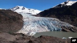 FILE - Chunks of ice float on Mendenhall Lake in front of the Mendenhall Glacier on May 30, 2022, in Juneau, Alaska. 