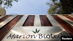 FILE - The logo of Marion Biotech, a health care and pharmaceutical company, is seen on a gate outside its office in Noida, India, Dec. 29, 2022.