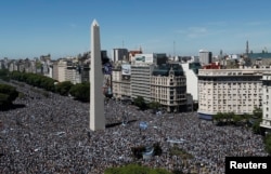 People flock to the Obelisco ahead of the victory parade for the players of the Argentine soccer team, in Buenos Aires, Dec. 20, 2022.