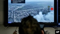 A Ukrainian soldier watches a drone feed from an underground command center in Bakhmut, Donetsk region, Ukraine, Dec. 25, 2022. (AP Photo/Libkos)