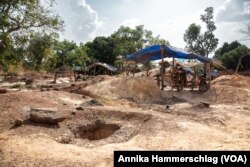 Open, unmarked pits that drop about 50 feet deep litter a gold mining site in Senegal's country's Kedougou region Nov. 16, 2022.