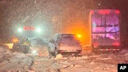 In this photo, taken Dec. 31, 2022, and released by California Highway Patrol, vehicles are stranded along Interstate 80 at the Nevada State line near Colfax, California.