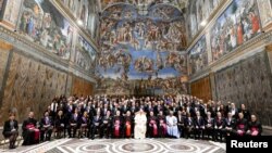 Pope Francis poses for pictures on the day of his "State of the World" address to diplomats, at the Vatican, Jan. 9, 2023. (Vatican Media/­Handout via Reuters) 