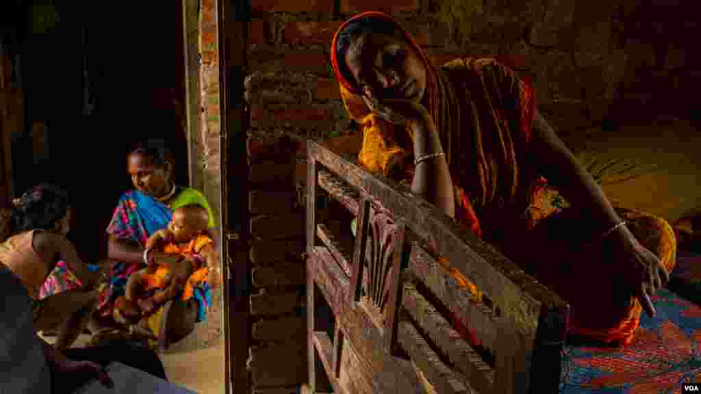 Urmila Sah cries when she speaks about her husband, Ram Narayan Sah Baniya, who died in Qatar just a few months ago, pictured in the Dhanusha district of Nepal, August 2022 (Yan Boechat/VOA)