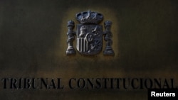 FILE - A plaque is seen at the entrance of Spain's Constitutional Court building in Madrid, Sept. 6, 2017.